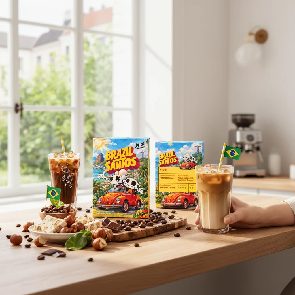 Lamora Brazil Santos coffee boxes with iced coffee, chocolate, and hazelnuts on a wooden kitchen table.