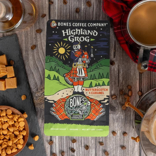Lamora Highland Grog decaf coffee bag featuring a skeleton in a kilt with butterscotch and caramel flavor notes.