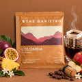 Lamora The Baristro Colombia Los Nogales specialty coffee drip bag with passion fruit, pineapple, and apple slices.